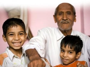 Picture of grandfatherly gentleman with two young boys, all smiling