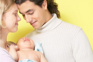 Picture of happy looking man and woman holding a baby Picture of happy looking man and woman holding a baby